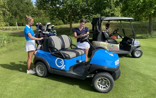 Vorteile IOTee Golfcart auf einem Golfplatz das mit IOTee ausgestattet ist und von zwei Frauen schlüssellos bedient wird.